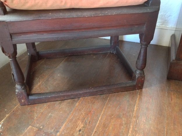 Jacobean style, a 17th century chair with unadorned stretchers between the feet. Only the masters of the household had chairs, everyone else had stools. 