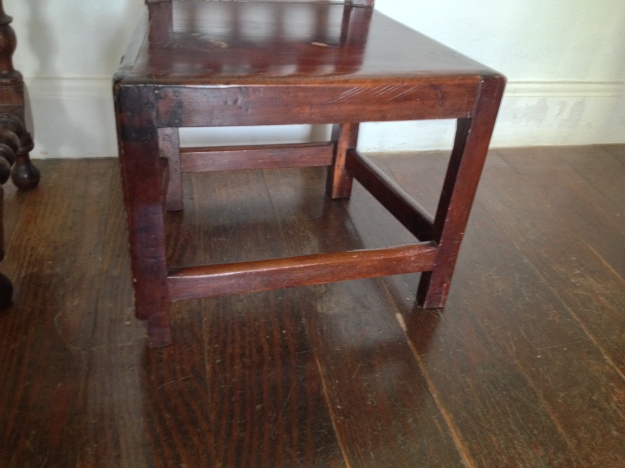 Simplicity of style indicates an early chair. The legs are supported by stretchers. 